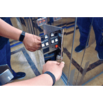 A technician accessing a maintenance control panel to service the system