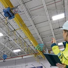 Image of Woman in Hard hat looking at Crane System