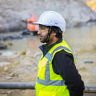 Image of a Man on Construction Site Wearing Safety Goggles, Safety Vest, and a Hard hat  