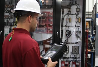Image of Man in Hardhat and Goggles working on Equipment