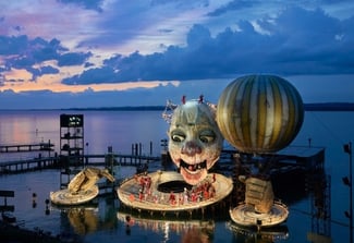 Image of Pfaff-silberblau BETA moving the collar of the Rigoletto on the lake stage at the Bregenz Festival