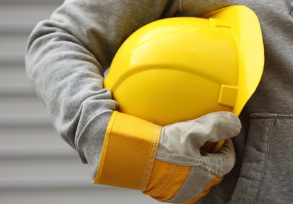 Image of Person Holding Hard Hat with Protective Gloves On