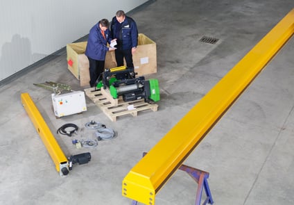 Image of Two People Working on a Crane kit 
