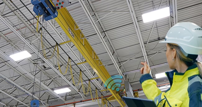 Image of Woman in Hard hat looking at Crane System