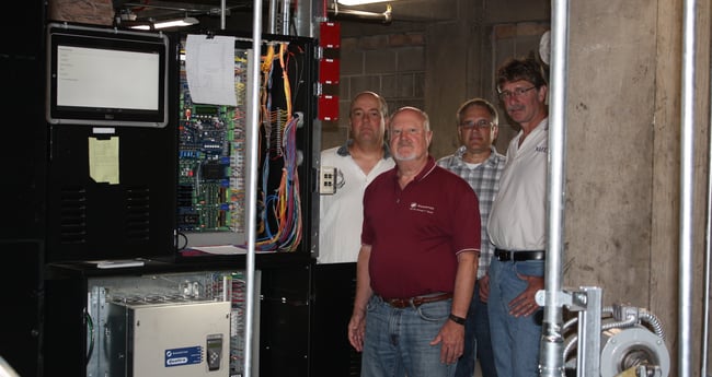 Photo of Three Men Standing around Elevator Refurbishment