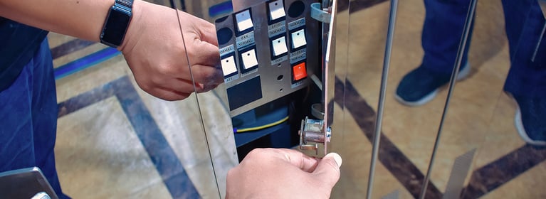 A technician accessing a maintenance control panel to service the system