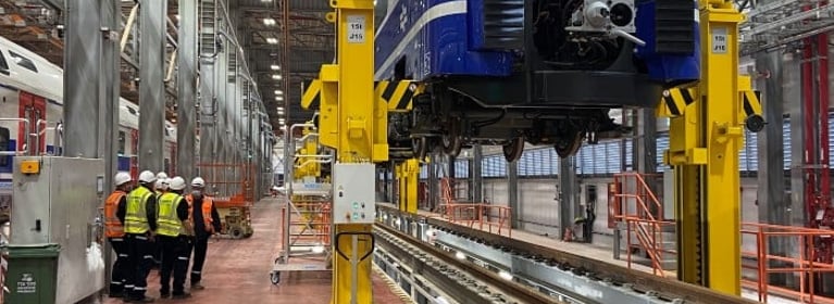 Image of Train Being Lifted By Crane System