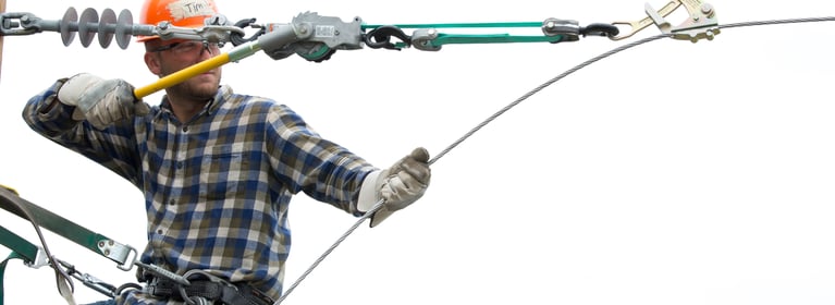 Electric Lineman on a pole using Little Mule Lineman's Strap Hoist and Wire Grips