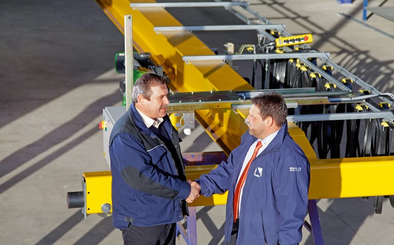 Image of two men shaking hands outside